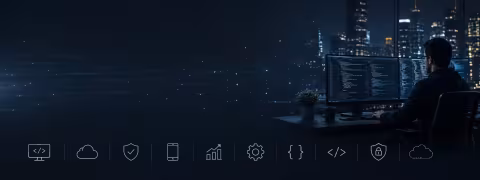 Silhouetted person at computer with cityscape in background at night.